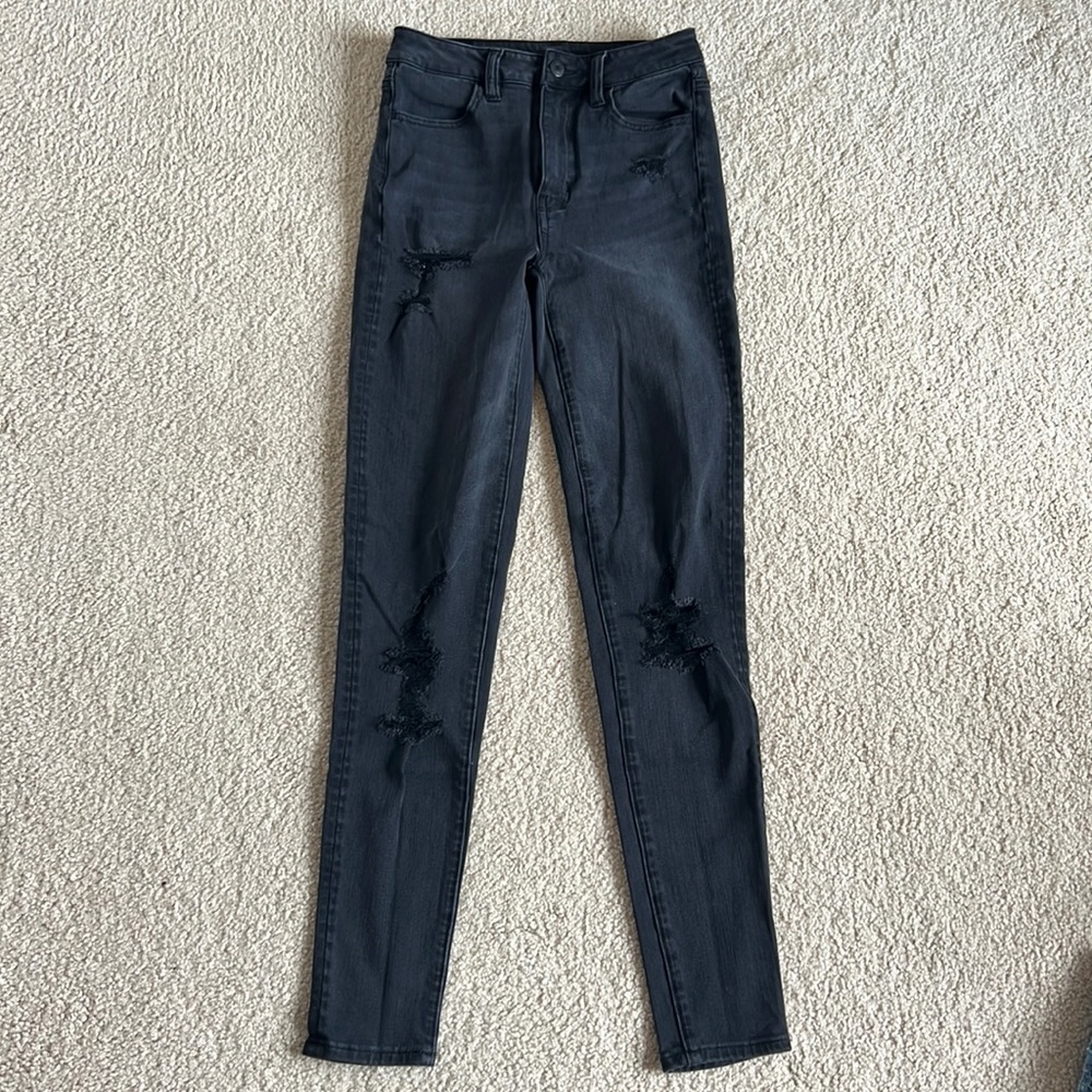 Distressed black skinny jeans